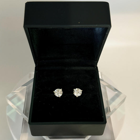 Close-up of 2.5 carat lab grown diamond stud earrings set in solid 14K gold, round cut, minimalist design on white background.