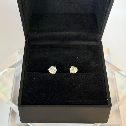 Close-up of 1 carat lab grown diamond stud earrings set in solid 14K gold, round cut, minimalist design on white background