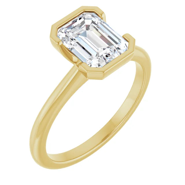 A gold engagement ring with a large, clear emerald cut gemstone set in the center of the band.