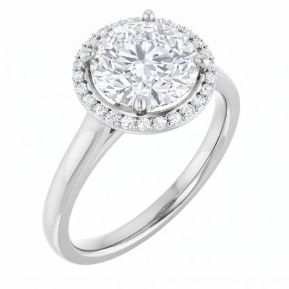 A silver engagement ring with a large, round diamond set in the center, surrounded by a halo of smaller diamonds.
