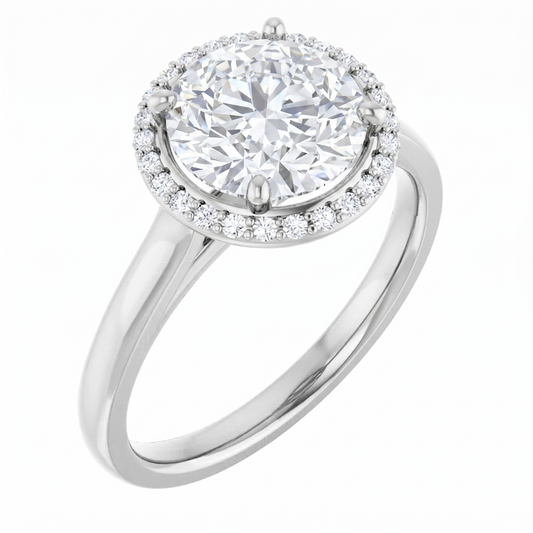 A silver engagement ring with a large, round diamond set in the center, surrounded by a halo of smaller diamonds.
