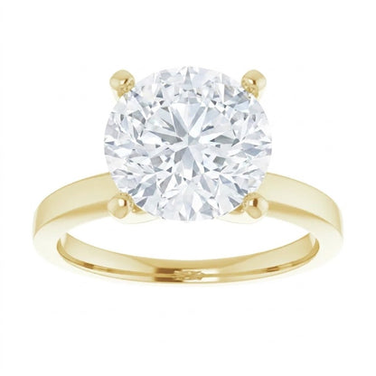 A gold engagement ring with a large, brilliant-cut diamond set in the center.