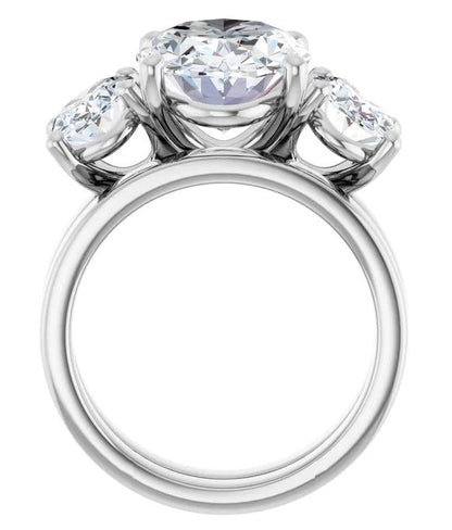 A silver ring with a large central diamond surrounded by smaller diamonds on either side.