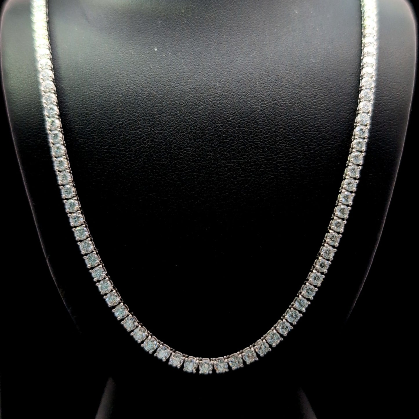 A close-up view of a diamond necklace on a mannequin, showcasing the intricate design and sparkling diamonds.
