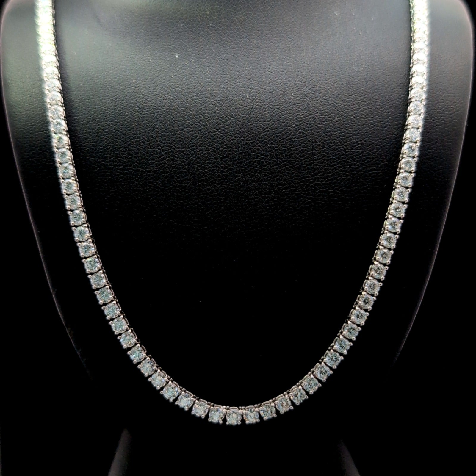 A close-up view of a diamond necklace on a mannequin, showcasing the intricate design and sparkling diamonds.