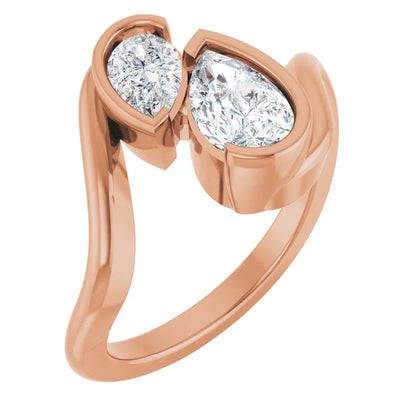 A rose gold ring with two large diamonds set in the center.