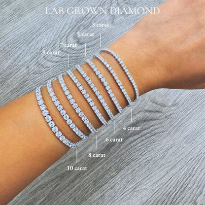 A close-up image of a person's wrist wearing a series of diamond-encrusted bracelets, each with a different carat weight ranging from 3 to 10.