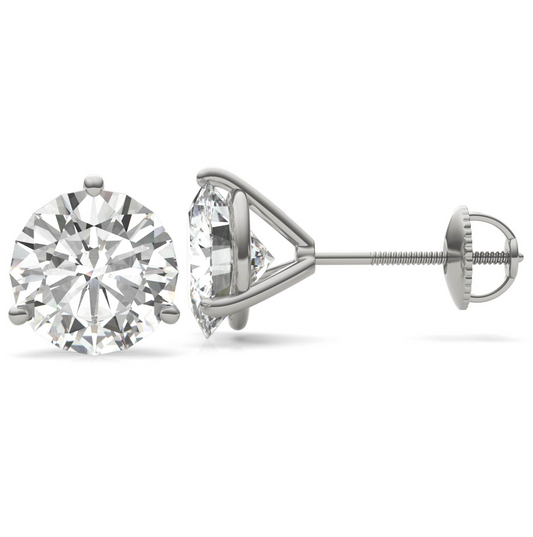 A pair of silver earrings with a large, clear diamond set in the center.