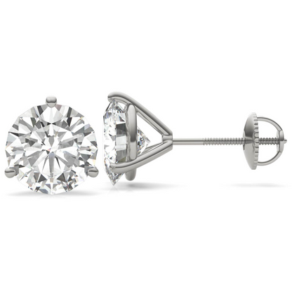A pair of silver earrings with a large, clear diamond set in the center.