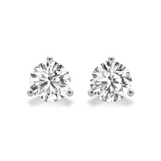 A pair of diamond earrings with large, clear gemstones set in silver.