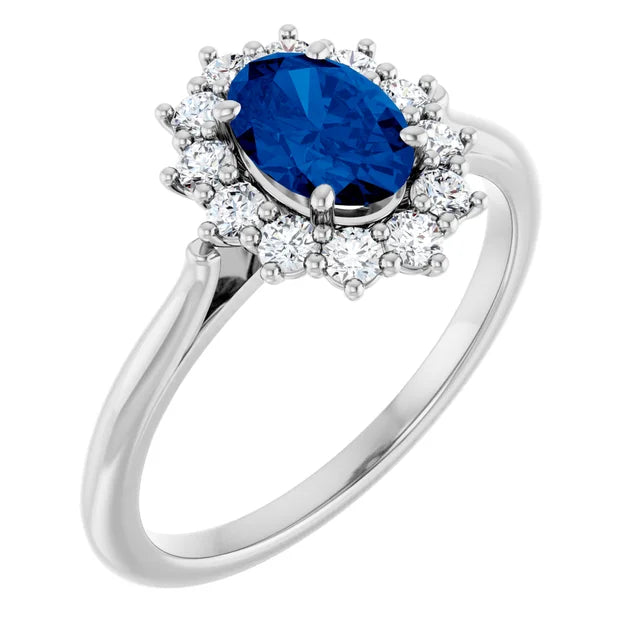 A silver ring with a large oval-shaped blue gemstone surrounded by smaller diamonds.