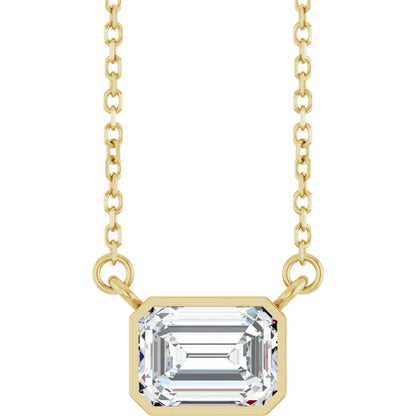 A gold necklace with a large, clear gemstone pendant.