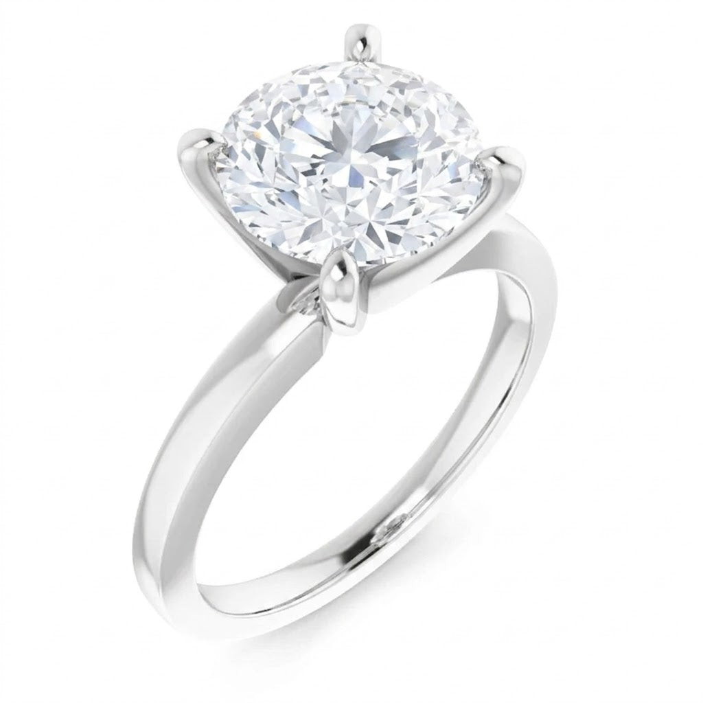 A silver engagement ring with a large, round diamond set in the center.