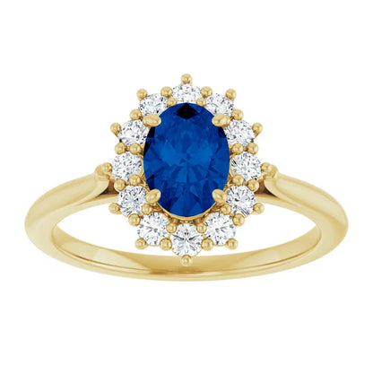 A gold ring with a large blue gemstone at the center, surrounded by smaller diamonds.