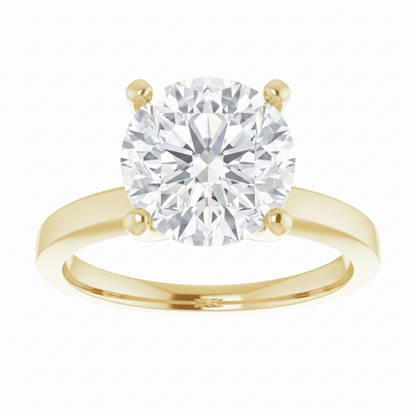 A gold engagement ring with a large, brilliant-cut diamond set in the center of the band.