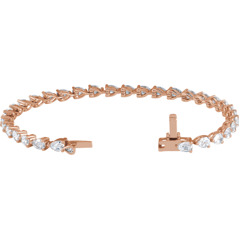 a beautiful rose gold bracelet with a row of small diamonds on it.