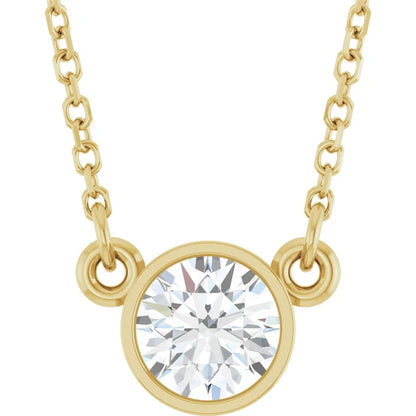 A gold necklace with a large, clear diamond pendant in the center.