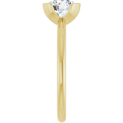 A gold engagement ring with a large diamond set in the center.