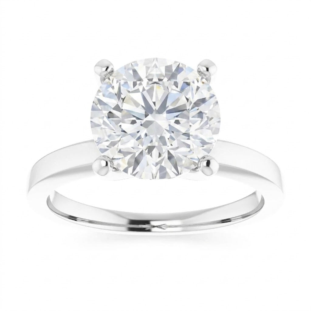 A close-up of a diamond engagement ring with a large, brilliant-cut diamond set in a silver band.