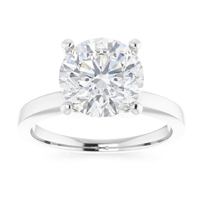 A close-up of a diamond engagement ring with a large, brilliant-cut diamond set in a silver band.