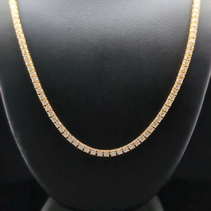 A gold necklace with small diamonds displayed on a black mannequin.