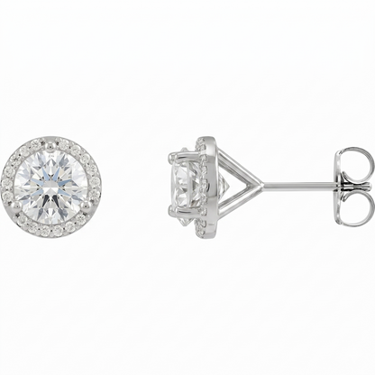 A pair of elegant silver earrings with a large, round diamond set in the center, surrounded by smaller diamonds.
