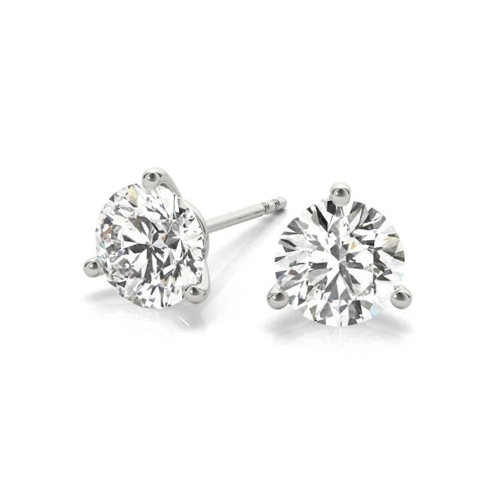 A pair of elegant diamond earrings with a large, brilliant-cut diamond set in a silver metal earring.