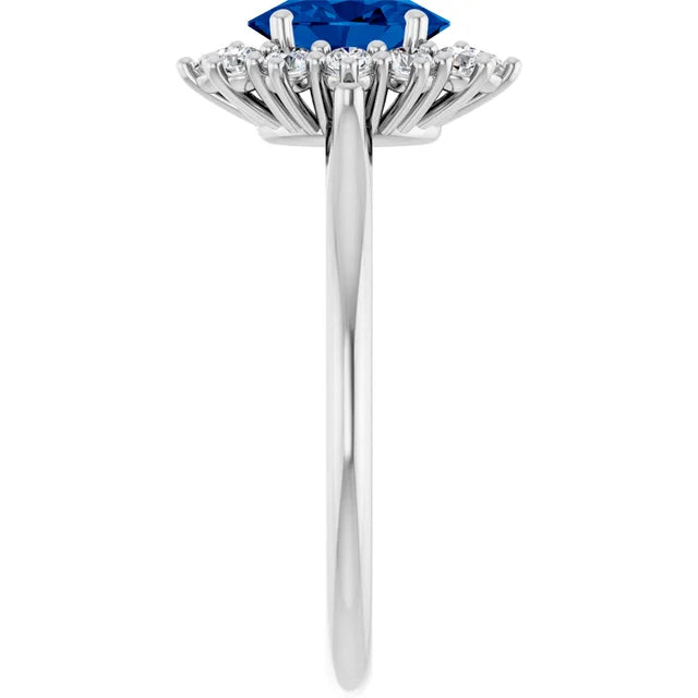 A silver ring with a large blue gemstone at the center, surrounded by smaller diamonds.