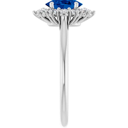 A silver ring with a large blue gemstone at the center, surrounded by smaller diamonds.
