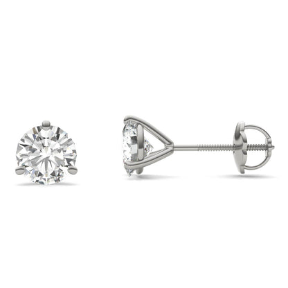 A pair of silver earrings with a large, clear diamond set in the center.