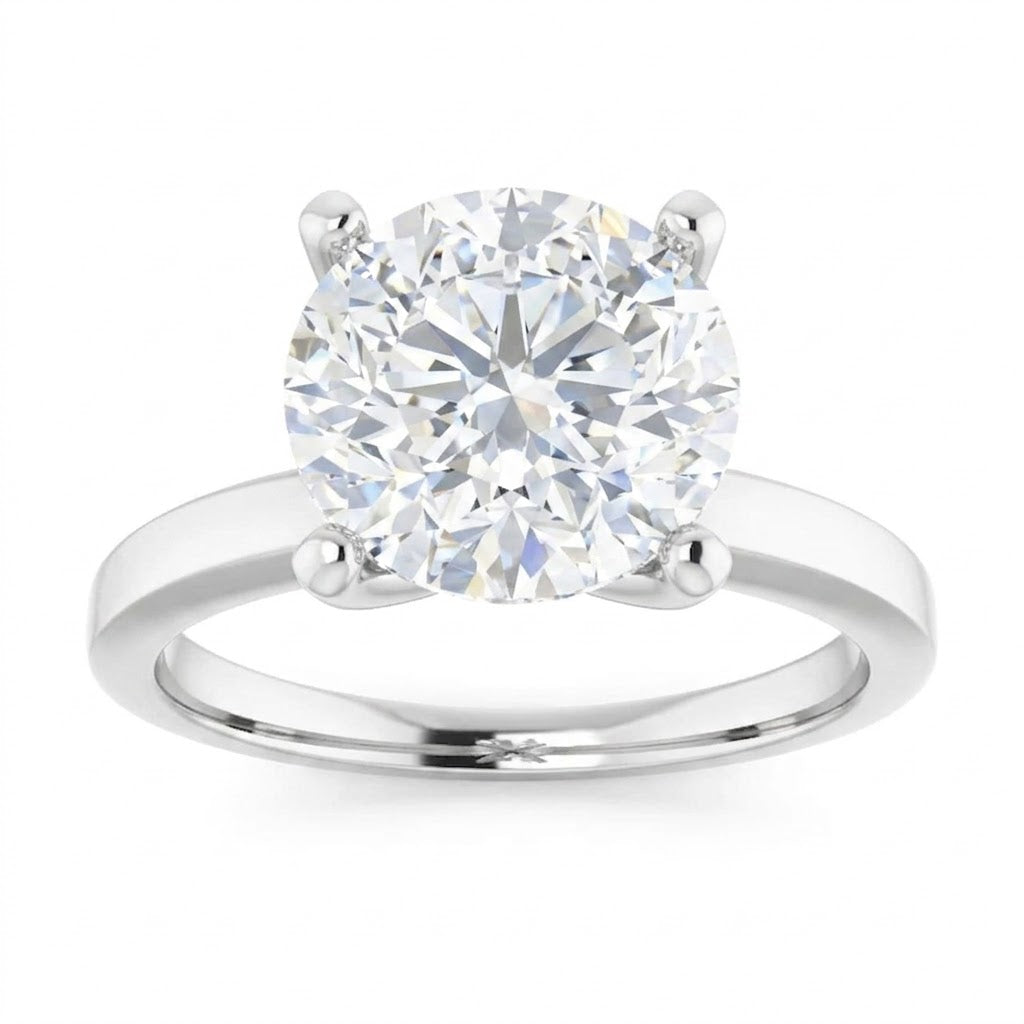 A large, brilliant-cut diamond engagement ring with a silver band.