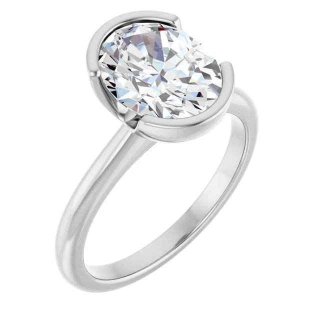 A silver engagement ring with a large oval-shaped diamond set in the center of the band.