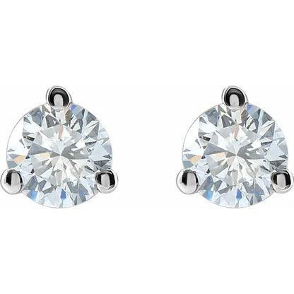 A pair of diamond earrings with a large, clear gemstone set in a silver metal frame.