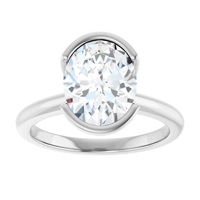 A silver engagement ring with a large, round diamond set in the center.