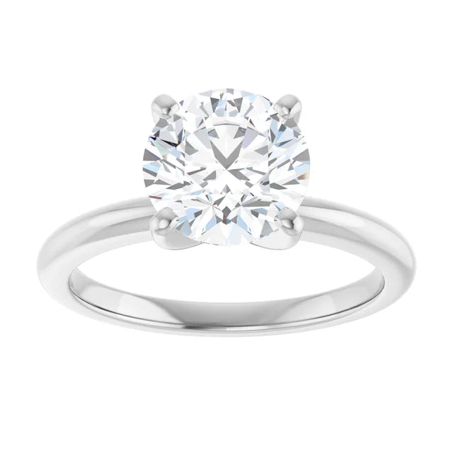 A close-up of a diamond engagement ring with a large, brilliant-cut diamond set in a silver band.