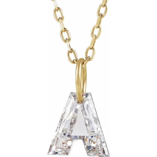 A gold-colored necklace with a large crystal letter "A" pendant.