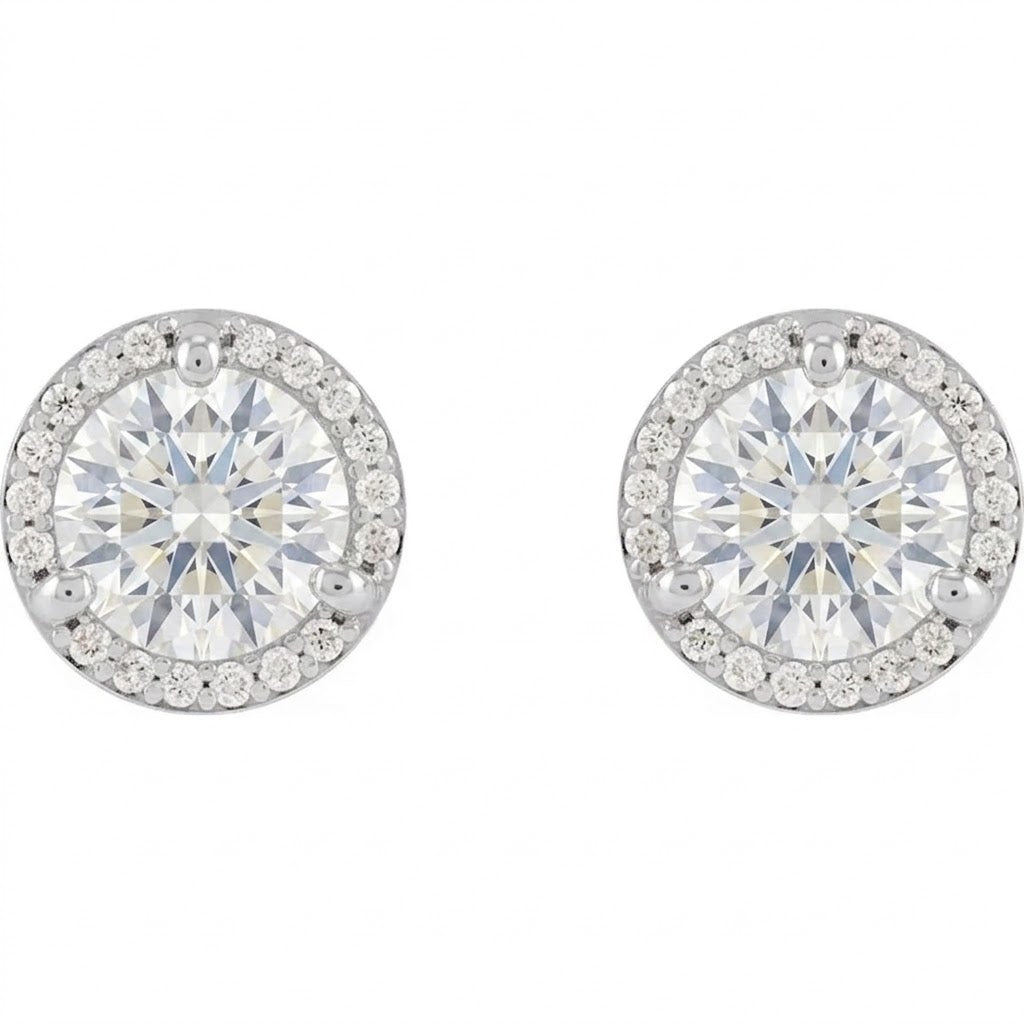 A pair of elegant earrings with large, brilliant-cut diamonds set in a halo of smaller diamonds.