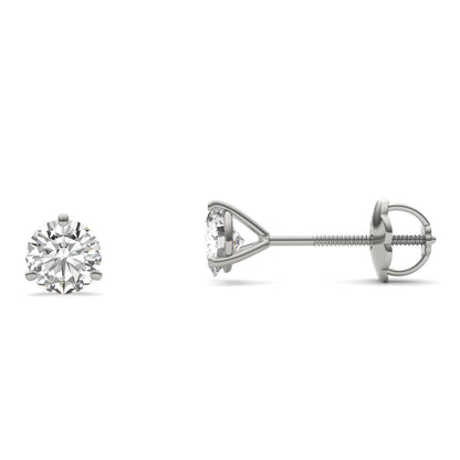 A pair of silver earrings with a single round diamond set in the center.