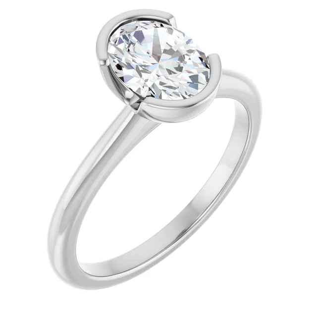 A silver engagement ring with a large oval-shaped diamond set in the center of the band.