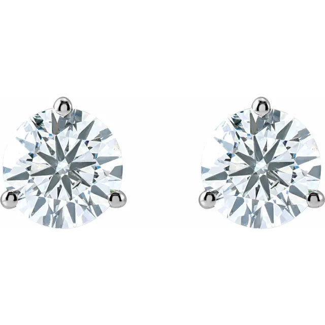 A pair of diamond earrings with large, clear gemstones set in silver posts.